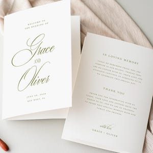 May include: Elegant wedding stationery featuring the names "Grace and Oliver" in a script font. The invitation is open, revealing the text and date. Gold wax seals and a wax melting spoon are also present.