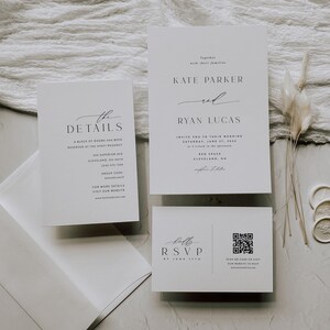 May include: Wedding invitation suite with white cardstock and black text. The invitation features the names "Kate Parker" and "Ryan Lucas" with the date "Saturday, June 17, 2023". The details card includes the location "430 Superior Ave Cleveland, OH" and the group code "KATE&RYAN". The RSVP card includes a QR code and the text "Scan QR code or visit our website to RSVP".