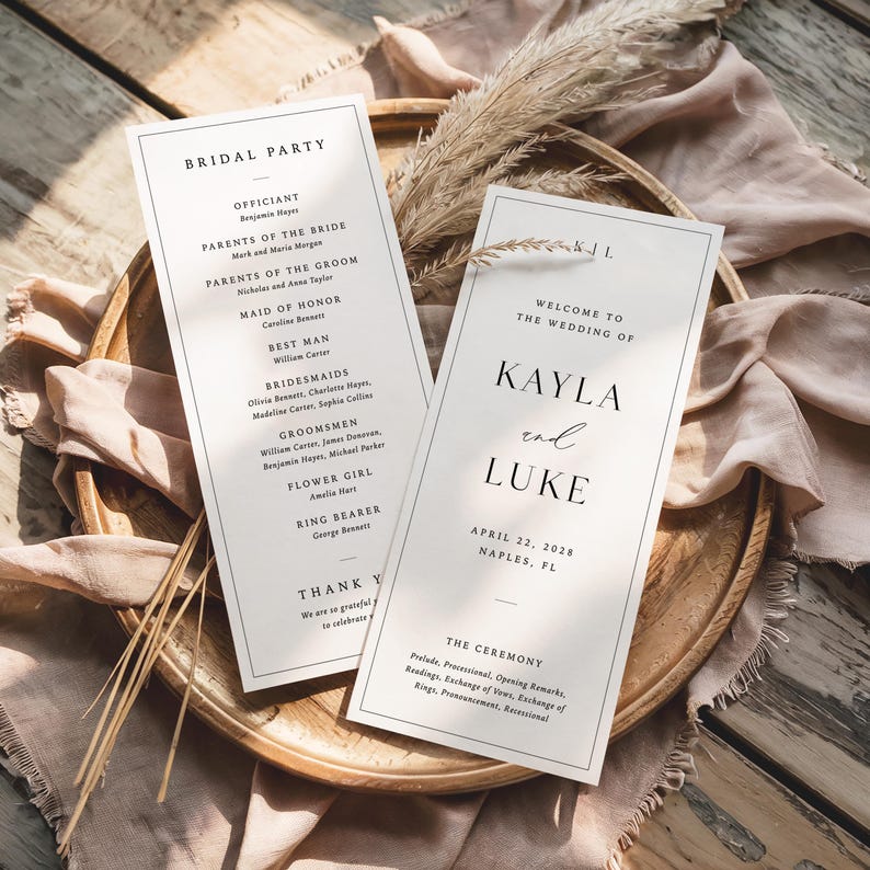May include: Two wedding programs with black text on a white background. One lists the bridal party, the other welcomes guests to Kayla and Luke's wedding on April 22, 2028, in Naples, FL. The programs are on a wooden tray, with dried flowers.