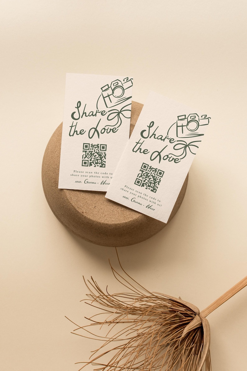May include: Two white cards with a green camera icon and the text "Share the Love" printed on them. Each card has a QR code and the text "Please scan the code to share your photos with us!" followed by the names "Gianna & Nico".