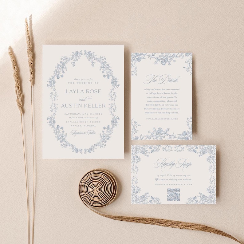 May include: A set of three wedding invitation cards with a blue floral design. The main card features the text "Please join us for the wedding of Layla Rose and Austin Keller". The second card has the text "The Details" and the third card has the text "Kindly RSVP" with a QR code.