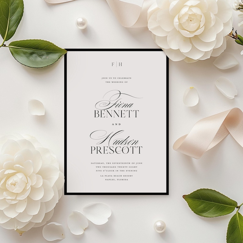 May include: A wedding invitation with a black border, featuring the names "Fiona Bennett" and "Hudson Prescott" in elegant script. The invitation is surrounded by white flowers, petals, a pearl, and a cream-coloured ribbon, creating a romantic aesthetic.
