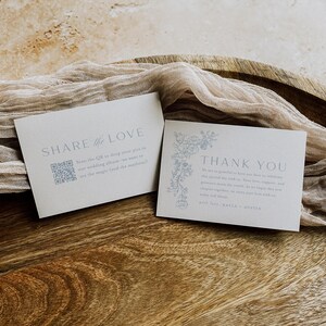 May include: Two rectangular white cards with grey text and floral illustrations. The left card reads SHARE the LOVE with a QR code. The right card reads THANK YOU with a floral border and text signed by Kayla and Austin, printed on heavy cardstock.