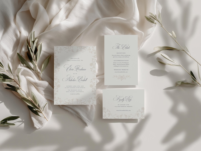 May include: A wedding invitation suite featuring a main card, a details card, and an RSVP card with elegant black serif typography on off-white paper. The cards are decorated with a subtle, light gray floral border pattern and are displayed alongside olive branches.