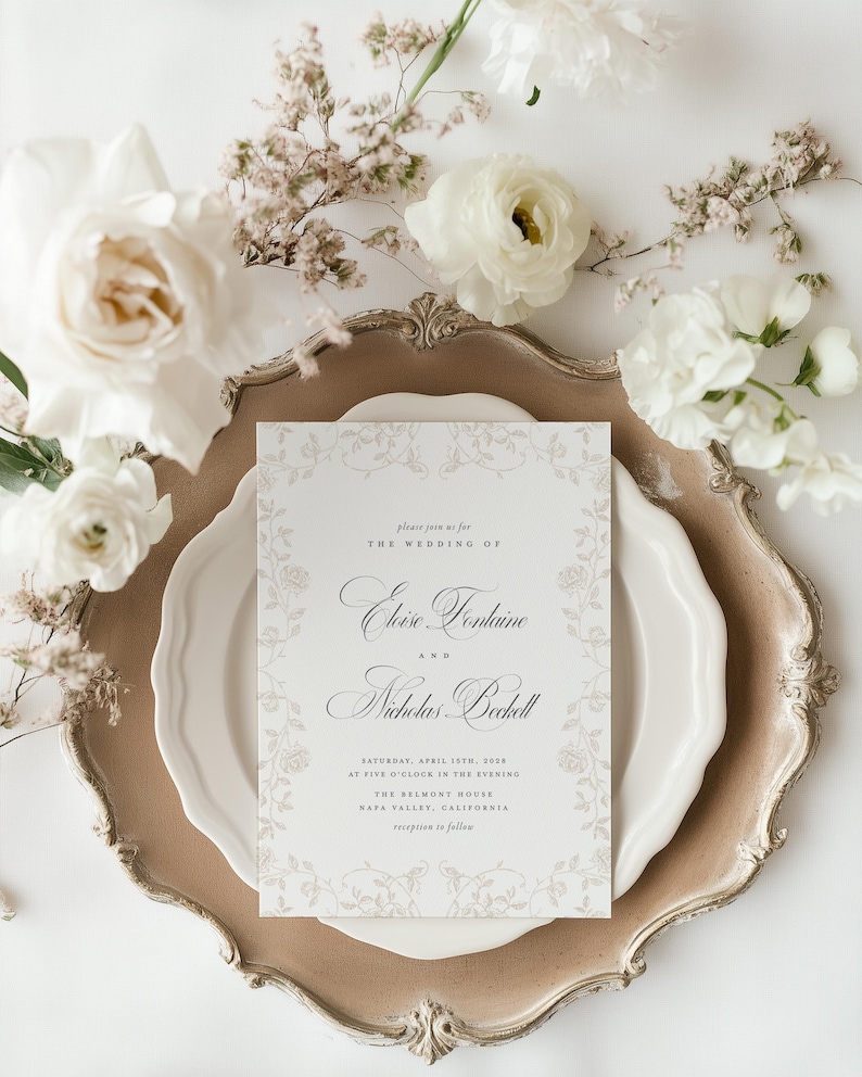 May include: A rectangular wedding invitation card with elegant black serif and script typography, featuring a delicate light gray floral border. The text reads: please join us for THE WEDDING OF Eloise Fontaine AND Nicholas Beckett SATURDAY, APRIL 15TH, 2028 AT FIVE O'CLOCK IN THE EVENING THE BELMONT HOUSE NAPA VALLEY, CALIFORNIA reception to follow.