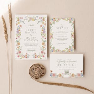 May include: Wedding invitation suite featuring floral borders in pastel colors. The main invitation includes names, date, and location. Additional cards provide details and a response request. A decorative ribbon and dried flowers are also present.