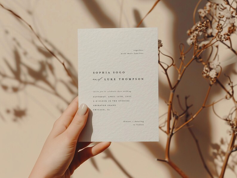 May include: A minimalist wedding invitation card with a cream background and black text. The card reads "Sophia Sogo and Luke Thompson" with the wedding date and time. The invitation states "Saturday, April 15th, 2023, 5 o'clock in the evening, The Sheraton Grand, Chicago, IL."