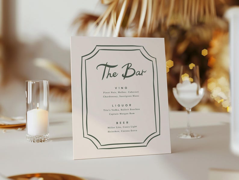 May include: A white sign with a green border and the text "The Bar" in a cursive font. The sign lists the drinks available at the bar, including wine, liquor, and beer.