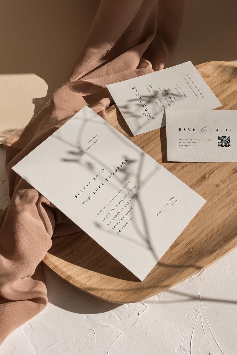 May include: A wedding invitation with a minimalist design featuring the names Sophia Sogo and Luke Thompson, the date Saturday, April 15th, 2023, and the time 5 o'clock in the evening. The invitation is printed on a cream-colored card with a shadow of a branch behind the text.