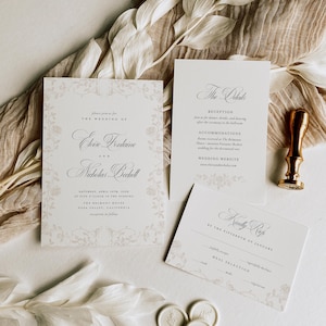 May include: A wedding invitation suite featuring a main invitation, a details card, and an RSVP card with floral borders and elegant typography. Includes a gold wax seal stamp and three small white wax seals with embossed floral designs.
