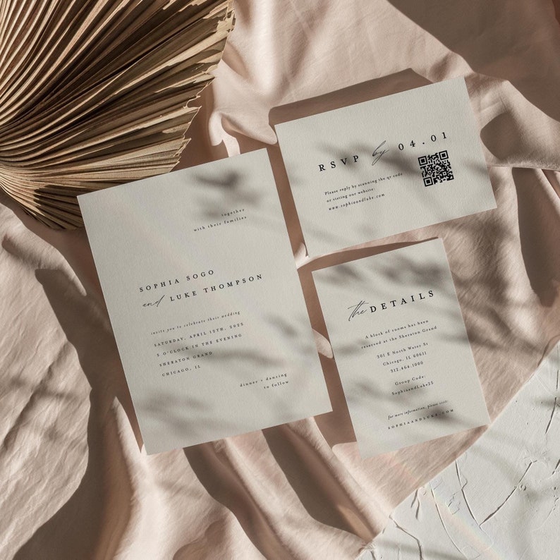 May include: Wedding invitation suite with a minimalist design. The invitation card features the names "Sophia Sogo and Luke Thompson" with the date "Saturday, April 15th, 2023" and the time "5 o'clock in the evening". The RSVP card has a QR code and the text "RSVP by 04.01". The details card has the text "The Details" and includes the venue, address, and group code.