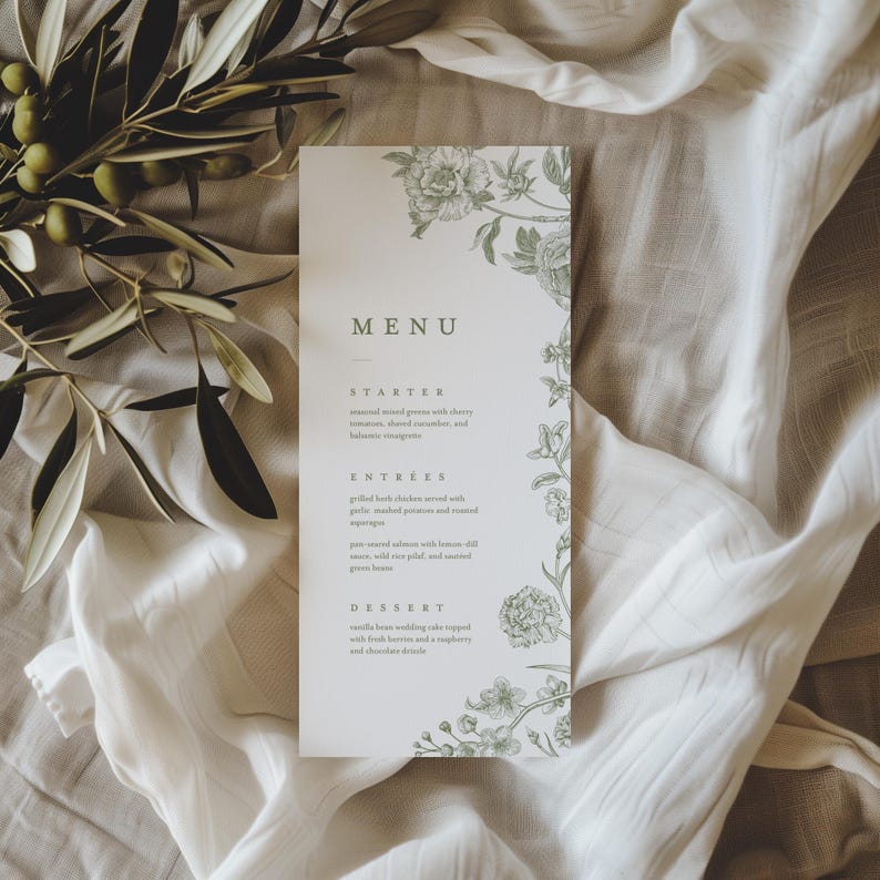May include: A vertical rectangular menu card printed on white paper with sage green botanical illustrations of flowers along the right edge. The text includes the headings Menu, Starter, Entrees, and Dessert with detailed food descriptions.