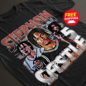 May include: Black t-shirt with a vintage-style graphic featuring a basketball player with the text "STEPHON CASTLE 5" in a silver, metallic font.