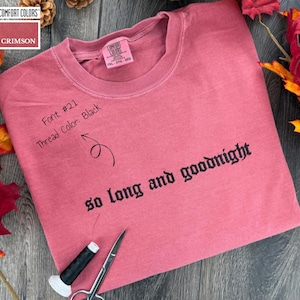 A pink comfort colors t-shirt with the text "so long and goodnight" embroidered on it,