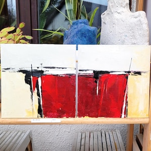 May include: A diptych painting featuring two rectangular canvases with a shared abstract composition. The artwork displays a bold horizontal band of vibrant red paint across the lower section, accented by thick black lines and white highlights.