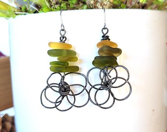 These spectacular earrings feature annealed iron flower charms and sea glass pebbles: "Fragments of Dreams"