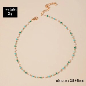 May include: A delicate necklace featuring small gold-tone beads interspersed with tiny square-shaped beads in shades of turquoise, emerald green, and white. The necklace includes a lobster clasp and an extender chain. Text states weight 3g and chain 35+5cm.