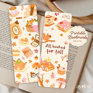 May include: Two rectangular printable bookmarks with fall-themed illustrations. One bookmark features a fox in a basket, and the other has a squirrel. Both have images of books, leaves, and food. The text "All booked for fall" is on one bookmark. Each bookmark is 2.5 x 7 inches.