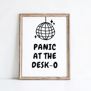 May include: Black and white printable art print featuring a disco ball and the text "Panic at the Desk-o".