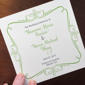 May include: Wedding ceremony announcement card with a green decorative border. The text reads "The Wedding Ceremony of Shannon Marie Benson & Steven Michael Shay April 27, 2013 Botanical Gardens Atlanta, GA"