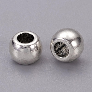 European style large hole silver alloy beads 10 x 5.5 mm wide, 5.5mm hole. Choose 5 bead or 10 bead packs.  Fits Euro style chain, cord