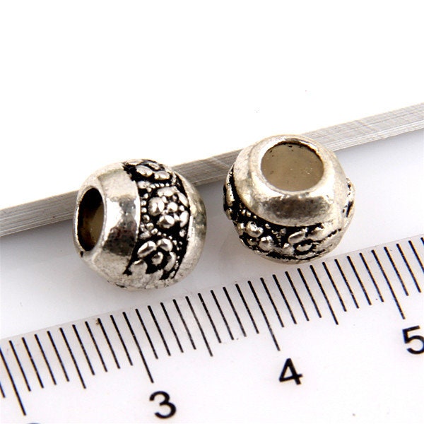 European style large hole barrel shape with flower pattern alloy beads. Pack of 2 or 4 beads. For Euro style snake chain, cord or leather