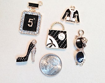 Black and white enamel and gold fashion charm group of 5 charms: Black & white purse, rhinestone high heel,perfume , sweater and sunglasses