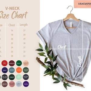 May include: A light gray V-neck t-shirt hanging on a wooden hanger, with a size chart and color options displayed. The size chart shows chest and length measurements in inches. The shirt is knotted at the bottom.