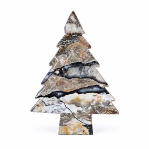 May include: A decorative tree-shaped ornament carved from polished stone, featuring a complex pattern of swirling brown, beige, white, and deep black veins throughout the surface, with a smooth finish and a flat, stable base for upright display.