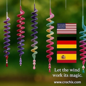 May include: Colorful, spiral-shaped wind chimes in various colors, including rainbow, purple, and red, hang against a blurred green background. Each chime has a beaded bottom. The text "Let the wind work its magic" is visible.