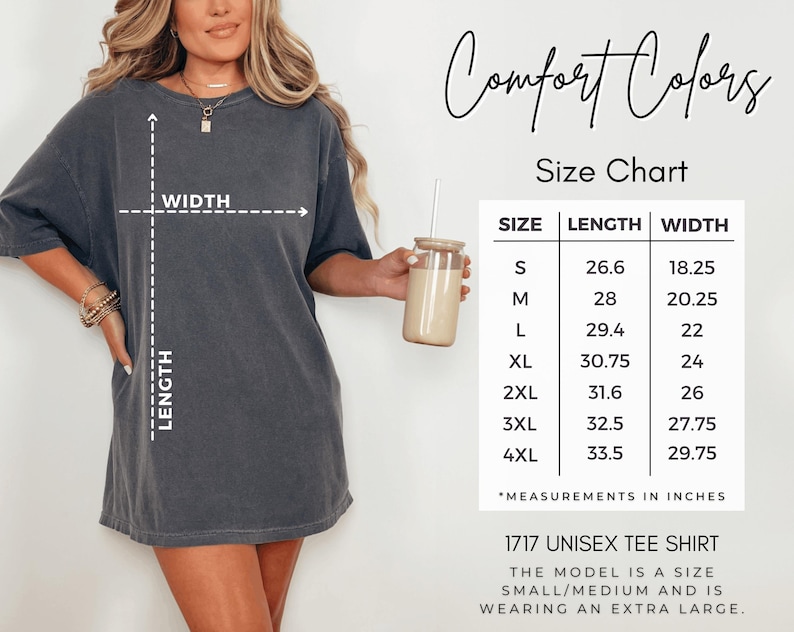 a woman wearing a grey t-shirt with measurements and a size chart for the t-shirt, along with a drink in a glass.