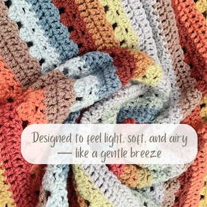 May include: A colorful, handmade crochet blanket with a variety of warm tones, including orange, brown, and yellow. The blanket has a textured appearance and is designed to feel light, soft, and airy.