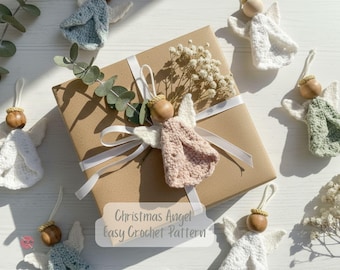 May include: Crocheted angel ornaments in white, pink, and green with wooden bead heads and white wings. A wrapped gift with a white ribbon and dried flowers is in the center. The text "Christmas Angel Easy Crochet Pattern" is visible.