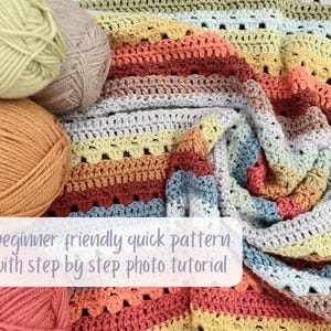 May include: A colorful, handmade crochet blanket with a striped pattern in shades of orange, yellow, gray, and blue. Several balls of yarn in complementary colors are arranged nearby. The text "Beginner friendly quick pattern with step by step photo tutorial" is visible.