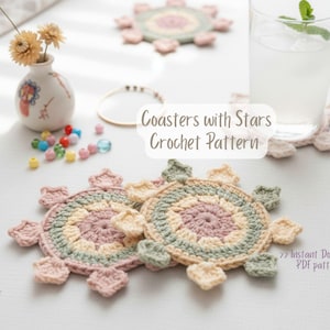 May include: Crocheted coasters with a star design in pastel colors. The coasters are circular with star-shaped edges, featuring shades of pink, green, and yellow. The image also includes a glass of water, a small vase with flowers, and the text "Coasters with Stars Crochet Pattern".