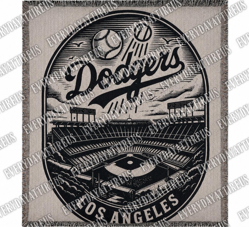 May include: A beige and black woven throw blanket featuring a detailed illustration of a baseball stadium with the text "Dodgers Los Angeles". The design includes baseballs, stadium elements, and the team's logo.