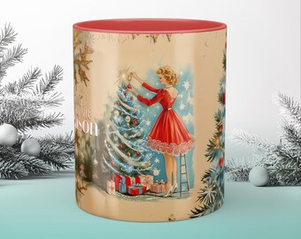 May include: A red and white Christmas themed mug with a vintage illustration of a woman decorating a Christmas tree. The mug has the text "It's the Season" on the side.
