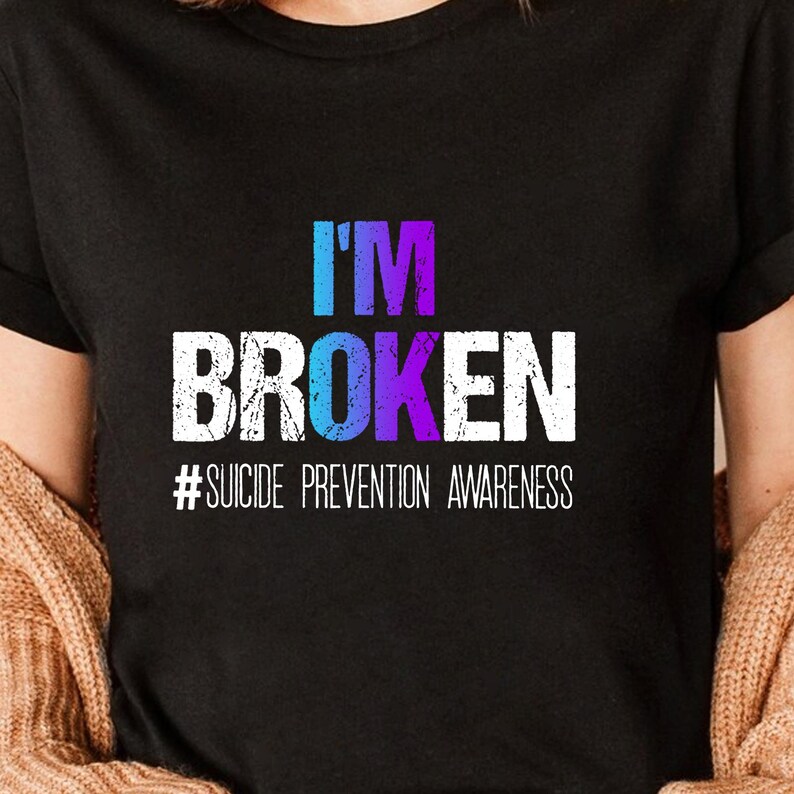 a woman wearing a t - shirt that says i'm broken suicide prevention awareness