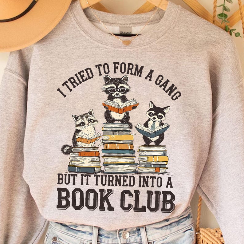 a raccoon is sitting on top of a stack of books