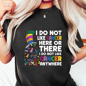 a woman wearing a t - shirt that says i do not like cancer here or