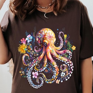 a woman wearing a brown shirt with an octopus on it