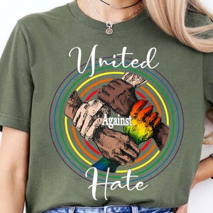 May include: Green t-shirt with a rainbow circle design and the words "United Against Hate".