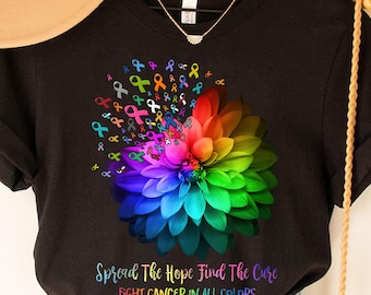 May include: Black t-shirt with a colorful flower design made of ribbon symbols. The text "Spread The Hope Find The Cure Fight Cancer In All Colors" is printed below the flower.