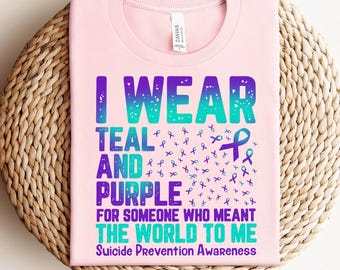 May include: Pink t-shirt with the text "I wear teal and purple for someone who meant the world to me" and "Suicide Prevention Awareness". The text is in a teal and purple gradient with teal and purple ribbon symbols.