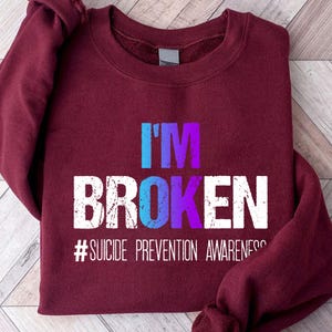 a red sweatshirt with the words i'm broken on it