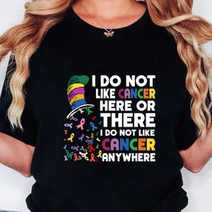 a woman wearing a t - shirt that says i do not like cancer here or