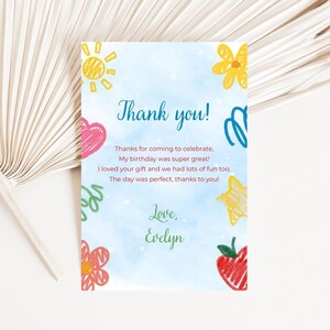 May include: A thank you card with a light blue watercolor background and colorful doodles of a sun, flowers, heart, star, and apple. The card reads "Thank you!" and includes a personalized message and signature.