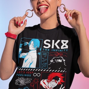 May include: Black t-shirt featuring anime-style graphics and text. The design includes characters with blue and red hair, the words "SK8 THE INFINITY," and Japanese text. The shirt also has the text "LET'S KEEP FEELINGS" and "2021 BONES STUDIO DIRECTED BY HIROKO UTSUMI."
