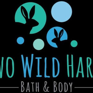 May include: Logo for Two Wild Hares Bath & Body, featuring two stylized silhouettes of hares in blue circles on a black background. The text is in green and blue.