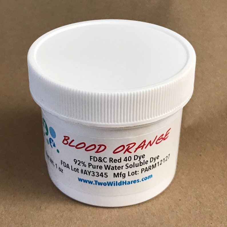 May include: A white plastic jar with a red label that says "BLOOD ORANGE" and contains FD&C Red 40 Dye. The label also includes the text "92% Pure Water Soluble Dye", "FDA Lot #AY3345", "Mfg Lot: PARM12127", and "www.TwoWildHares.com".